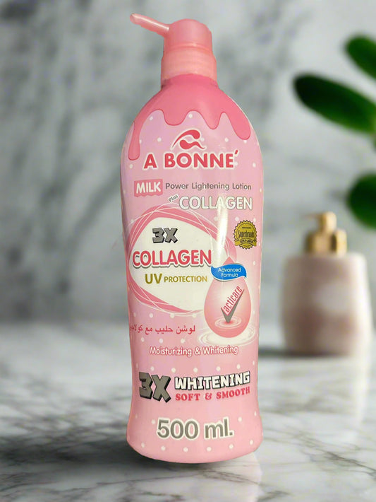 Pink bottle of A Bonne milk power lightening lotion with collagen on a marble surface.