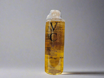 Bottle of VC skincare product on a gray background