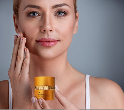 Woman holding a jar of skincare product with a neutral background